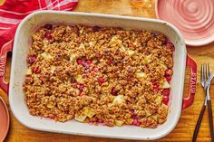 a casserole dish with cranberries, apples and oatmeal in it