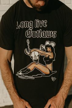 El Ray Long Live Outlaws art is licensed Comfort Colors T-shirt is true to size. Size up for more oversized fit Unisex Fan Merchandise Graphic Tee With Back Print, Graphic Tee With Back Print For Fan Merchandise, Band Merch Cotton T-shirt With Custom Artwork, Cotton Band Merch T-shirt With Custom Artwork, Relaxed Fit Tops With Back Print For Fans, Custom Artwork Graphic Tee With Short Sleeves, Custom Artwork Crew Neck Top For Fan Merchandise, Graphic Tee With Custom Artwork And Short Sleeves, Graphic Tee With Custom Artwork And Relaxed Fit