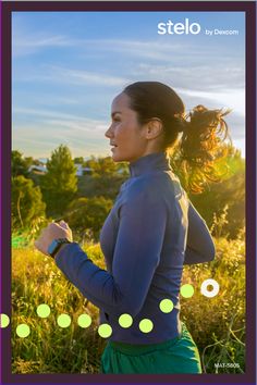 a woman is running through the grass with her hair in a ponytail and green pants