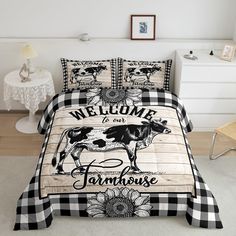 a black and white checkered bed cover with a cow on the front, welcome to our farmhouse