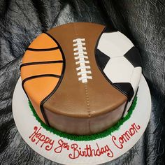 a birthday cake with a football and soccer ball on it