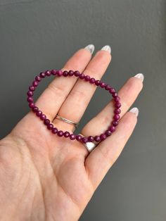 Since ancient times, rubies have symbolized passion, protection, and wealth. Many cultures have strong ties to it being a symbol of love and commitment. Stone is ruby. The beads are faceted Bead size: 4mm Bracelet Size: 7 inches & stretchy Faceted Round Beads Stretch Bracelet As Gift, Faceted Round Bead Stretch Bracelet Gift, Ruby Beaded Bracelets With Round Beads As Gift, Ruby Beaded Bracelets With Gemstone Beads As Gift, Ruby Beaded Bracelets With Round Beads For Gift, Ruby Beaded Bracelets As A Gift, Gift Ruby Gemstone Beaded Bracelets, Spiritual Stretch Bracelet With Faceted Details As Gift, Spiritual Faceted Stretch Bracelet As A Gift