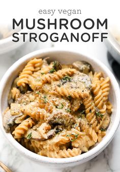 a white bowl filled with mushroom stroganoni on top of a marble counter