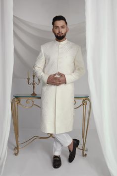 Elevate your style with our White Long Sherwani. With an off-white abstract print, this sherwani boasts a cotton silk kurta and pure cotton pajama for ultimate comfort. Perfect for special occasions, this sherwani will make you stand out in the crowd while looking sophisticated and stylish. 3-Piece Suit Designer Cotton Bandhgala For Eid, Designer Cotton Kurta For Formal Occasions, Designer Off-white Bandhgala For Eid, Off White Naqshi Bandhgala, Designer Off White Kurta For Eid, Designer Off-white Kurta For Eid, Off White Naqshi Sherwani For Diwali, Designer White Nehru Jacket, Designer Off White Kurta With Resham Embroidery