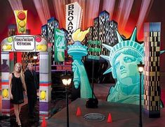 a woman standing in front of a statue of liberty booth