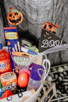 a basket filled with candy and halloween decorations