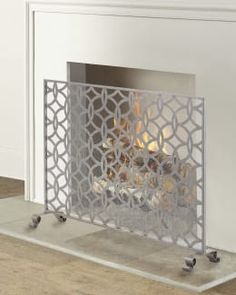 a white fireplace with a fire in it