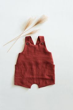 a baby's red romper with ears on top