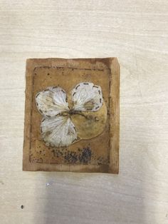 a piece of wood that has some kind of flower on it