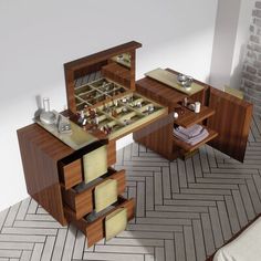 a wooden table with drawers and other items on it in a room that looks like a herringbone tile floor