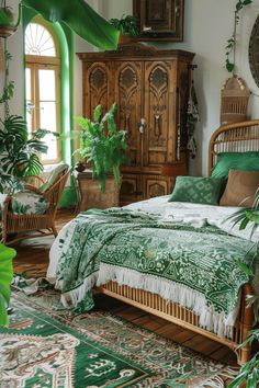 a bed with green sheets and pillows in a room filled with potted greenery