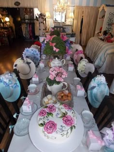 a table is decorated with pink and blue flowers