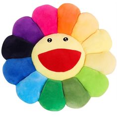 a multicolored flower shaped plush toy on a white background