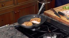 some food is being cooked in a pan on top of the stove and ready to be eaten