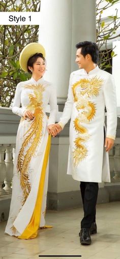 a man and woman dressed in traditional chinese clothing holding hands while standing next to each other