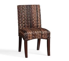 a brown and black woven chair with wooden legs