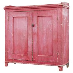 an old red wooden cabinet with two doors and one drawer on the bottom, isolated against a white background