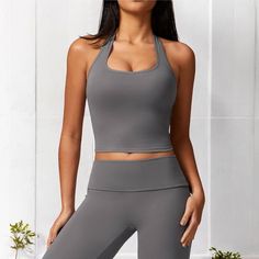 The Anna-Kaci Women's Ribbed Halter Neck Sports Bra with Built-In Bra is a stylish and functional piece perfect for your casual and active wardrobe. Made from soft, stretchy ribbed fabric, this Sports Bra features a flattering halter neck design that accentuates the shoulders and offers a chic, sporty look. The built-in bra provides added support and comfort, making it ideal for low-impact activities or everyday wear. The cropped length pairs beautifully with high-waisted jeans, leggings, or ski Racerback Sports Bra, Jeans Leggings, Bra Shop, Bra Straps, T Shirt Bra, Sporty Look, Bra Cups, Ribbed Fabric, Comfortable Outfits