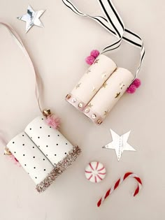 some candy canes and other decorations on a white surface with stars, candies, and paper