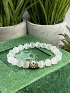 You will ABSOLUTELY LOVE this Beautiful Genuine Selenite Crystal Bracelet with  High Quality CZ Evil Eye Accent Bead. Available in 8mm or 6mm Selenite Choose from Silver or Gold Evil Eye Selenite is Excellent to keep Negative Energies Away! Selenite - (Crystal for Crown & Third Eye Chakras) This Gorgeous Selenite Bracelet  is a Gift they will ABSOLUTELY LOVE ! ❤️ All Bracelets are Crafted from High Quality GENUINE Gemstone Beads sourced from Reputable Healing Crystal Suppliers. You are buying a Spiritual White Beaded Bracelets With Evil Eye, White Spiritual Bracelets For Healing, White Hypoallergenic Spiritual Beaded Bracelets, White Spiritual Stretch Bracelet With Gemstone Beads, White Evil Eye Bracelet With 8mm Beads As Gift, White Spiritual Stretch Bracelet Gift, Spiritual White Gemstone Beads Stretch Bracelet, White Evil Eye Bracelet Gift, Spiritual White Evil Eye Bracelets