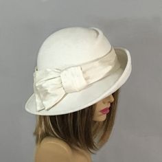 This beautiful ladies hat is made from lush fur felt, and hand draped over an antique hat block. Hand finished with authentic millinery techniques. Has millinery wire to maintain its shape. Embellished with Dupioni Silk. This is the perfect flattering hat...asymmetrical, diagonal front draping, with my signature pleating in the crown. Please indicate your head size measurement when ordering (measure your head horizontally just above your eyebrows). When you receive your hat, there will be a smal Elegant Beige Fur Felt Fedora, Elegant White Brimmed Felt Hat, Elegant Wide Brim Felt Hat For Kentucky Derby, Elegant Beige Wool Felt Hat, Classic Felt Hat For Kentucky Derby Evening, Classic Evening Felt Hat For Kentucky Derby, Classic Kentucky Derby Evening Felt Hat, Evening Felt Hat With Short Brim, Elegant Felt Hat For Kentucky Derby