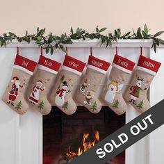 christmas stockings hanging from a mantel over a fire place