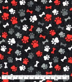 a black background with red and white dog paw prints on it, next to a ruler