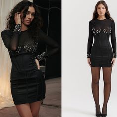 the model is wearing a black dress with sheer sleeves and sequins on it