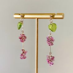 Are you looking to add a pop of color and artisan style to your accessory collection? These Bohemian glass bead earrings are just what you need. Handcrafted by skilled artisans using centuries-old Czech glasswork techniques, each pair features a unique cascade of colorful glass beads, shaped and painted to look like wildflowers, fruits, and vines. Don't you love how the handmade process results in one-of-a-kind designs? The beautiful thing about these handcrafted earrings is that they go with ev Jewelry Hooks, Fruit Earrings, Handcrafted Earrings, Beaded Dangles, Czech Glass Beads, Long Earrings, Czech Glass, Colored Glass, Beautiful Earrings