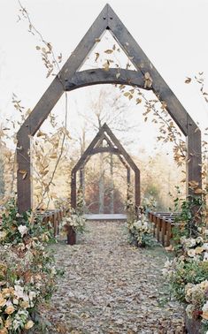 an outdoor wedding ceremony with flowers and greenery