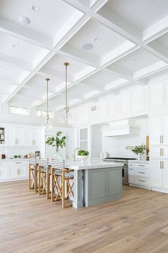 the instagram page on instagram shows an open kitchen with white cabinets and wood floors