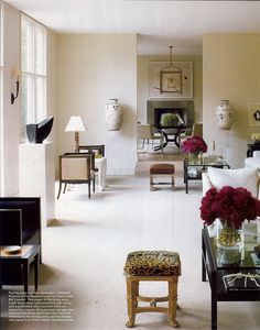 a living room filled with furniture and flowers