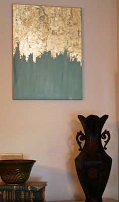 two vases sitting on top of a white shelf next to books and a painting