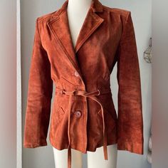 Stunning 1970s Jacket! The Perfect 70s Style Burnt Orange In Color. Slight Vintage Wear Throughout. Size Small But Can Fit Xs As Well Has Some Light Signs Of Vintage Wear And I Believe One Center Button Missing, But The Tie Is There So It’s Not Seen. Measurements: Waist: 14” (Tie Can Cinch To Smaller) Chest: 17.5” (Pit To Pit) Length: 25.5” Sleeves: 23” (From Shoulder) Vintage Leather Jacket With Long Sleeves For Fall, Vintage Long Sleeve Leather Jacket For Fall, Retro Long Sleeve Leather Jacket For Work, Vintage Leather Outerwear For Spring, Retro Fall Outerwear For Vintage Fashion, Retro Fitted Leather Jacket For Fall, Fitted Retro Leather Jacket For Fall, Retro Leather Jacket For Spring, Spring Retro Leather Jacket