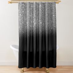 a black and white shower curtain with silver glitter on the bottom, in front of a bathtub