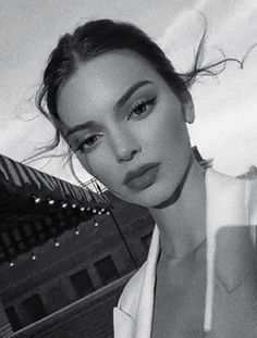 a black and white photo of a woman with her hair blowing in the wind on instagram