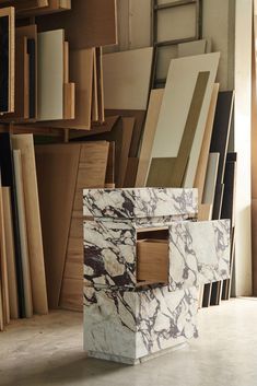 marble blocks stacked on top of each other in front of bookshelves and shelves