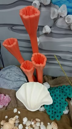 some corals and seashells are sitting on a table