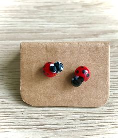 pair of ladybug earrings on brown card