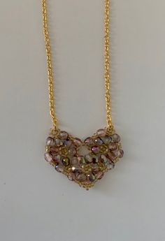 beaded pendant pale pink heart pendant pink fire polished crystals gold seed beads heart shape bling pendant gold chain This is a beaded pendant in pale pink earth tone type colours. This is a  heart pendant, made from pink fire polished crystals, woven into circles and edged using gold seed beads to create  heart shape. The cut on the crystals makes this a  bling pendant. The pendant is strung on a gold chain, with a lobster clasp completing it. Pink Earth, Pink Heart Pendant, Polished Crystals, Pink Fire, Pendant Gold, Beaded Pendant, Pink Heart, Heart Shape, Pale Pink