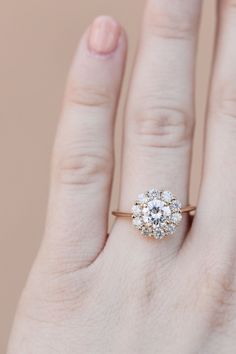 a woman's hand with a diamond ring on it