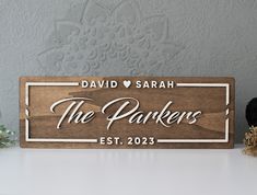 personalized wooden sign with name and date for the parkers est 2055 on it