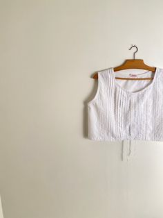 "Vintage white cotton pin tuck blouse with crew neck collar. Lovely cropped oversized fit. Unlined. Materials: cotton Condition: very good vintage condition Size: M on the tag, estimated to fit s frames Measurements: shoulders: 38 cm or 15\" bust: 51 cm or 20.1\" waist: 51 cm or 20.1\" length: 39 cm or 15.3\" Measurements are taken seam to seam while lying flat Follow this link to see all the tops available in the shop: https://www.etsy.com/fr/shop/peneloppevintage?ref=shop_sugg&section_id=21637 Pin Tuck Blouse, Vintage Cotton Crop Top, Cropped Cotton Crop Top For Daywear, Cotton Cropped Crop Top For Daywear, Vintage White Summer Crop Top, Vintage White Crop Top For Spring, Vintage White Crop Top For Summer, White Vintage Crop Top For Summer, White Crop Top Blouse For Daywear