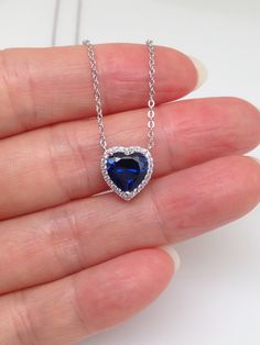 925 Sterling Silver Cz Sapphire Heart Halo Pendant Necklace   - Metal: 925 Sterling Silver (Finish: Rhodium Plated) - Stone: Clear Cubic Zirconia/Lab-Created Blue Sapphire, Round/Heart Cut,                 Prong/Pave - Shape: Heart - Pendant Dimension: Height 10mm(0.39 in) x Width 9.8mm(0.385 in), Thickness 5mm/3mm. (Please note that center sapphire heart is 8mm x 7.8mm, Tiny.) - Light Cable Chain: 17.5" Adjustable (15.5" + 1" + 1"), Lobster Clasp - Color: Silver Valentine's Day Sapphire Necklace Gift, Valentine's Day Gift Sapphire Necklace, Heart-shaped Lab-created Sapphire Jewelry For Valentine's Day, Valentine's Day Heart-shaped Lab-created Sapphire Jewelry, Valentine's Day Sapphire Silver Jewelry, Heart Cut Lab-created Sapphire Jewelry Gift, Sapphire Cubic Zirconia Jewelry For Valentine's Day, Elegant Jewelry With Lab-created Sapphire For Valentine's Day, Elegant Lab-created Sapphire Jewelry For Valentine's Day