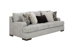 a gray couch with pillows on it and some black and white throw pillows in the back