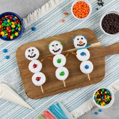 marshmallow snowman cupcakes on a wooden board