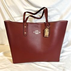 New Coach 72673 Town Tote Polished Pebble Leather Wine Shoulder Bag New With Tags Coach Town Tote Coach Town Tote Style: 72673 Color: Wine Retail Price: $398.00 + Tax Polished Pebble Leather Inside Zip Pocket Snap Closure Handles With 8 3/4" Drop 12 1/4" (L) X 12 1/2" (H) X 4 3/4" (W) Gold Tone Hardware Dust Bag Not Included Some Bags Have Lost There Tags Do To Showing Them Or Taking Pictures But All Are New And Unused. Rectangular Pebbled Leather Shoulder Bag For Shopping, Rectangular Pebbled Leather Bag For Shopping, Red Bags For Everyday Use With Smooth Grain, Daily Use Pebbled Leather Shoulder Bag With Branded Hardware, Red Smooth Grain Bag For Everyday, Coach Textured Leather Rectangular Bags, Classic Pebbled Leather Shoulder Bag For Shopping, Classic Coach Bags With Textured Leather, Red Bags With Smooth Grain