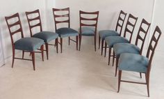 a set of eight chairs with blue upholstered seats