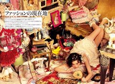 a woman laying on top of a bed in a room filled with lots of stuff