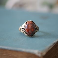 14 x 10mm cabochon on an antiqued sterling silver plated or brass adjustable ring. Easy to adjust to any size. Choose from Tigereye, Goldstone, Carnelian or Leopardskin Jasper. Tigers Eye Ring, Leopardskin Jasper, Cameo Bracelet, Orange Ring, Jasper Jewelry, Cameo Ring, Cabochon Ring, Cabochons Stones, Eye Ring